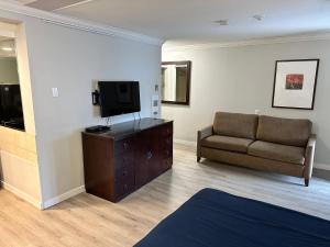 a living room with a couch and a television at Travelodge by Wyndham Langley in Langley