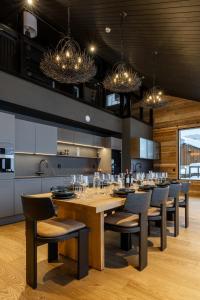 a dining room with a large wooden table and chairs at Penthouse Sammon in Levi