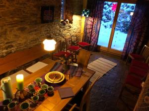 a dining room with a wooden table with a candle at Ferienhaus Lebenswerkstatthof in Mildenau