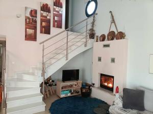 a living room with a staircase and a fireplace at H BIΛΑ ΤΩΝ ΟΝΕΙΡΩΝ ΣΟΥ-999 THE VILLA OF YOURS Dreams 999 in Drama