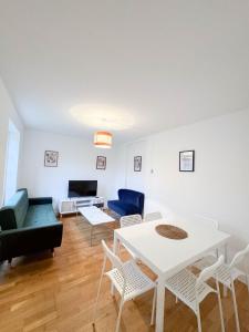 a living room with a table and chairs and a couch at LA CASITA in Colindale