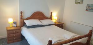 a bedroom with a large bed with two night stands at Eden Rose Cottage in Morecambe