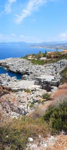 a rocky hillside with the ocean in the background at Janis Home in Chrani