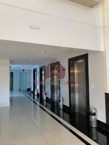 a hallway with stainless steel elevators in a building at Piazza diRoma com acesso ao Acqua Park - Gualberto in Caldas Novas