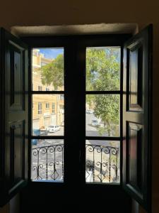 an open window with a view of a street at Tal-Kaptan in Victoria