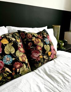 a bed with two pillows with flowers on it at Powdermill Lodge in Hanworth