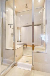 a bathroom with a shower with a glass door at Stunning Historic Home - DT Location! - Sleeps 8 in Denver +19 photos