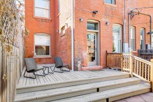a porch with two chairs and a table on it at Stunning Historic Home - DT Location! - Sleeps 8 in Denver