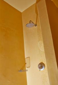 a bathroom with a shower with a drain in the ceiling at EDGE ON VOLCANO SUITES in Fira