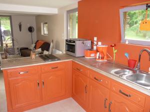 a kitchen with a sink and a microwave at Gite "la Solitude" in Licques