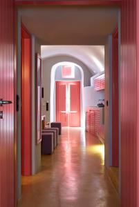 a hallway with a red door in a room at EDGE ON VOLCANO SUITES in Fira