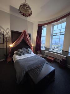 a bedroom with a bed and a large window at The Office Bar and Restaurant in Dudley