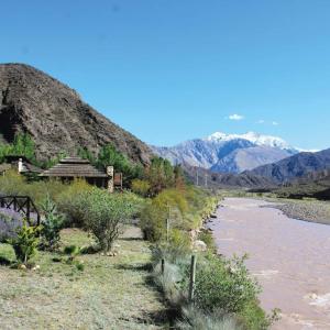 a view of a river with mountains in the background at Cabaña Las Flores in Potrerillos
