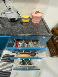a kitchen counter with a sink and a dishwasher at Millennia service apartments in Hyderabad
