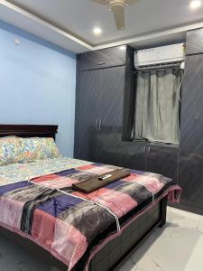 a bed in a room with a window and a window at Millennia service apartments in Hyderabad