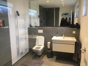 ペーネミュンデにあるExklusives FERIENHAUS im Yachthafen Peenemünde - mit Seeblickのトイレ、洗面台、鏡のあるバスルーム +22枚の写真