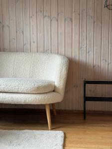 a living room with a white couch and a table at Ristiku Guesthouse in Kuressaare