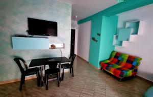 a room with a table and chairs and a couch at Diego Rooms Vlora in Vlorë