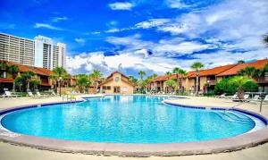 a large swimming pool in a resort at Sunny Daze, Desirable Kid Friendly Resort, 3 minute walk to the Beach, Resort Beachside Pool & Restaurant in Panama City Beach