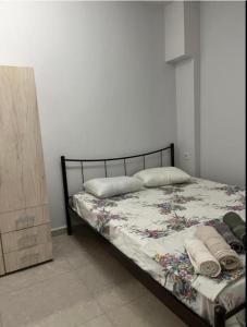 a bedroom with a bed and a wooden dresser at White Studio in Néa Michanióna