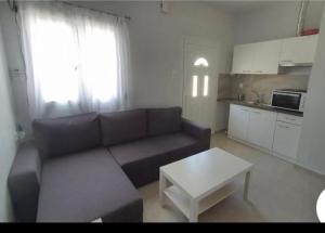 a living room with a couch and a coffee table at White Studio in Nea Michaniona