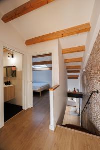 a living room with a brick wall at Atico Duplex Playa Area Barcelona con SPA exterior in Montgat