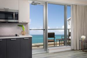 a kitchen with a view of the ocean at Casa Costera, Isla Verde Beach, Apartments by Marriott Bonvoy in San Juan