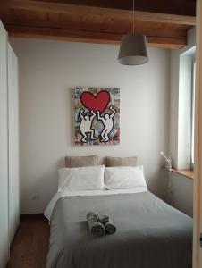 a bedroom with a bed with shoes on it at La Finestra sul Porto Apartment in Ancona