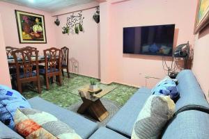 a living room with a blue couch and a table at Apartamento Maya y Mía in Santa Ana