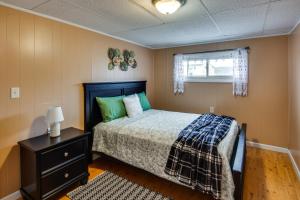 Un dormitorio con una cama con almohadas verdes y una ventana en Family-Friendly Altoona Abode with Spacious Patio!, en Altoona