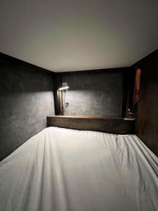 a bed with a white sheet on top of it at JOOOOY building 2Kai - Vacation STAY 60626v in Amami