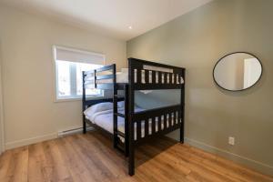 two bunk beds in a room with a mirror at Perché Private Hot Tub Pool Table Peaceful in Brownsburg