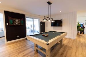 a room with a pool table and a dart board at Perché Private Hot Tub Pool Table Peaceful in Brownsburg