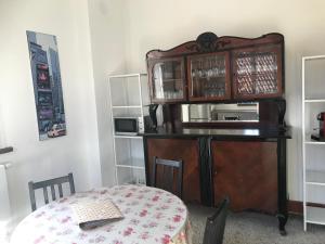 a room with a table and a cabinet with a microwave at Haus Anna - Schloss Hürbel in Gutenzell-Hürbel