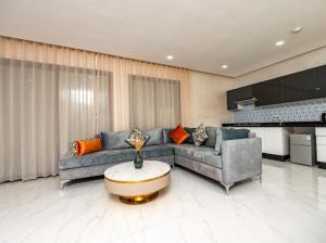 a living room with two couches and a table at Maarif elite suites in Casablanca