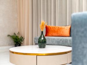 a green vase sitting on a table in a living room at Maarif elite suites in Casablanca