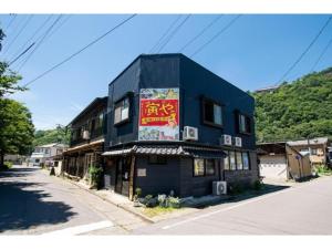 a black building on the side of a street at Showa No Toraya - Vacation STAY 61518v in Chikuma