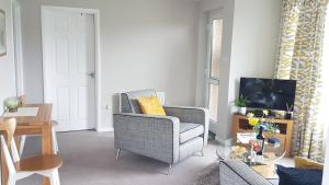 a living room with a chair and a television at Harbour cottage sleeps 4 nr Marina Eastbourne in Pevensey