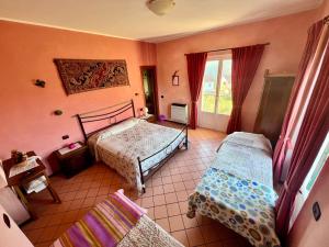 a bedroom with two beds and a window at La Casa Rosa in Borghetto di Vara +34 photos