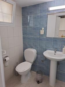 a bathroom with a toilet and a sink at GALATEX BEACH STUDIO in Limassol