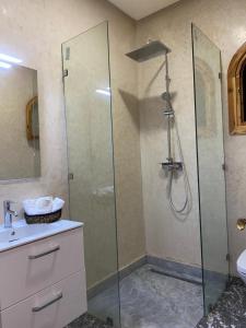 a bathroom with a shower with a sink and a toilet at DAR RITA in Taghazout +16 photos