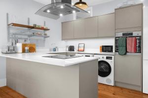 a kitchen with a sink and a washing machine at Station Skyline Two By My Getaways in Brighton & Hove