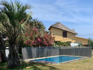 a fence around a swimming pool in front of a house at Pucara del Este in Punta del Este