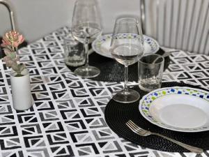 a table with wine glasses and plates on a table at La Dimora Del Cuore Antico in Sassari