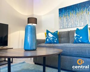 a living room with a blue vase on a table at 2 Bedroom Apartment by Central Serviced Apartments - Monthly Bookings Welcome - FREE Street Parking - WiFi - Smart TV - Ground Level - Family Neighbourhood - Sleeps 4 - 1 Double Bed - 2 Single Beds - Heating 24-7 - Trade Stays - Weekly & Monthly Offers in Dundee