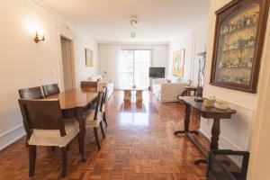 a dining room with a table and chairs and a living room at Apartment in Recoleta in Buenos Aires