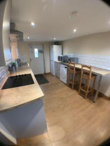 a kitchen with a table and a counter top at The Dairy, quiet countryside location near York in Wilberfoss