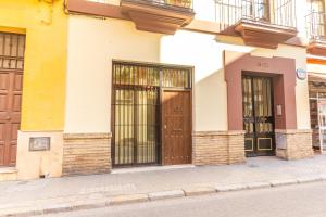 a building with three doors on a street at AlohaMundi San Esteban III in Seville