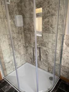 a shower with a glass enclosure in a bathroom at The Dairy, quiet countryside location near York in Wilberfoss