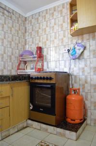 a kitchen with a stove top oven in a kitchen at ELDORET STAYS in Eldoret